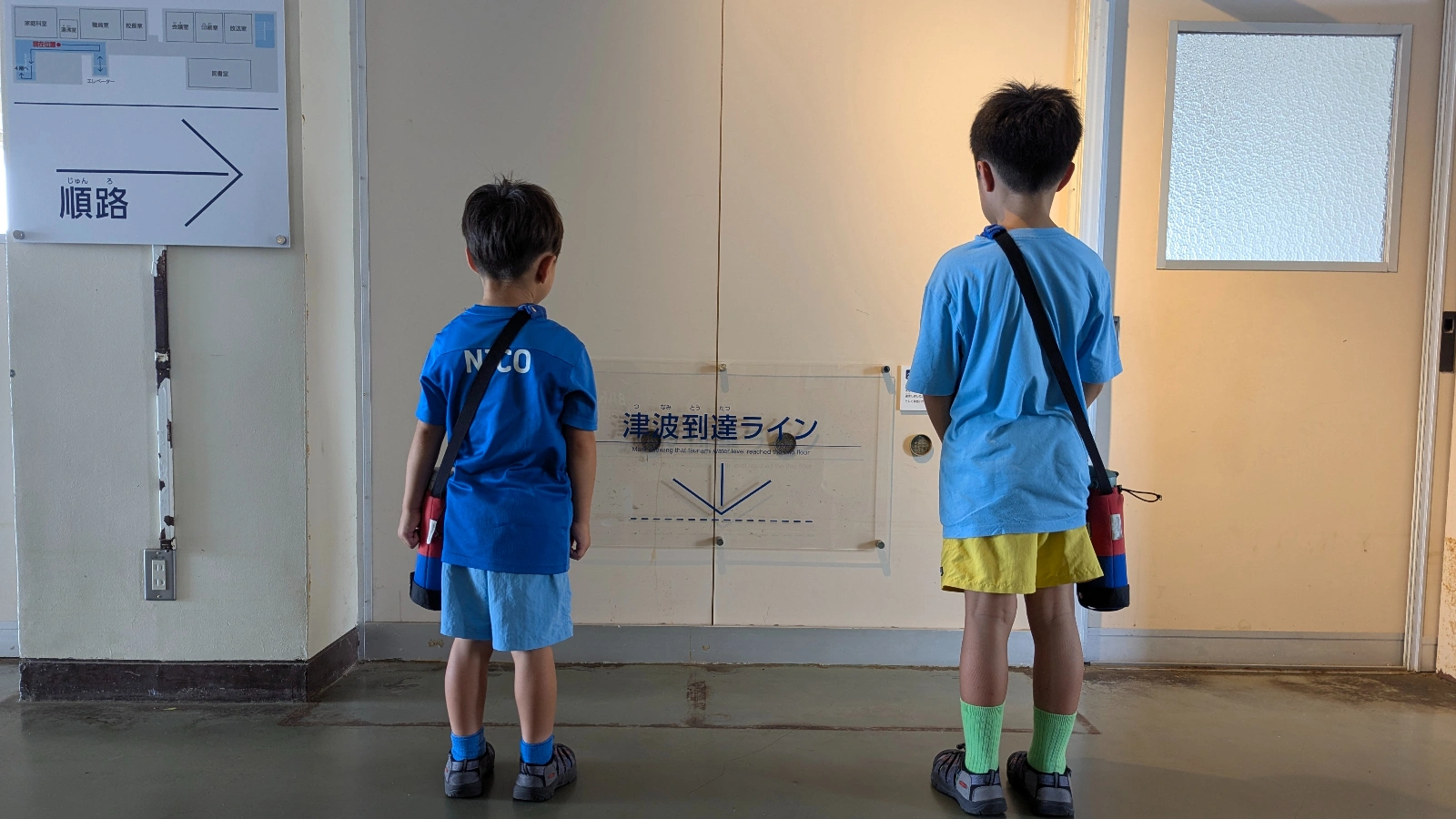 Two children observe the tsunami reach line inside Arahama Elementary School in Sendai, Japan, part of the Earthquake Heritage Memorial Museum.
