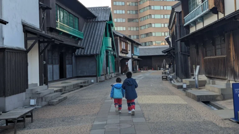Luca & Nico exploring the historical streets of Dejima Island Nagasaki, a family-friendly open-air museum in Japan.