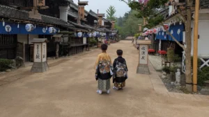 Two children dressed in samurai-style kimono walking through Edo Wonderland Nikko Edomura, an immersive ninja and samurai theme park.