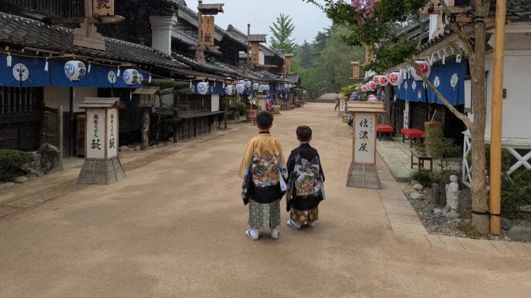 Two children dressed in samurai-style kimono walking through Edo Wonderland Nikko Edomura, an immersive ninja and samurai theme park.