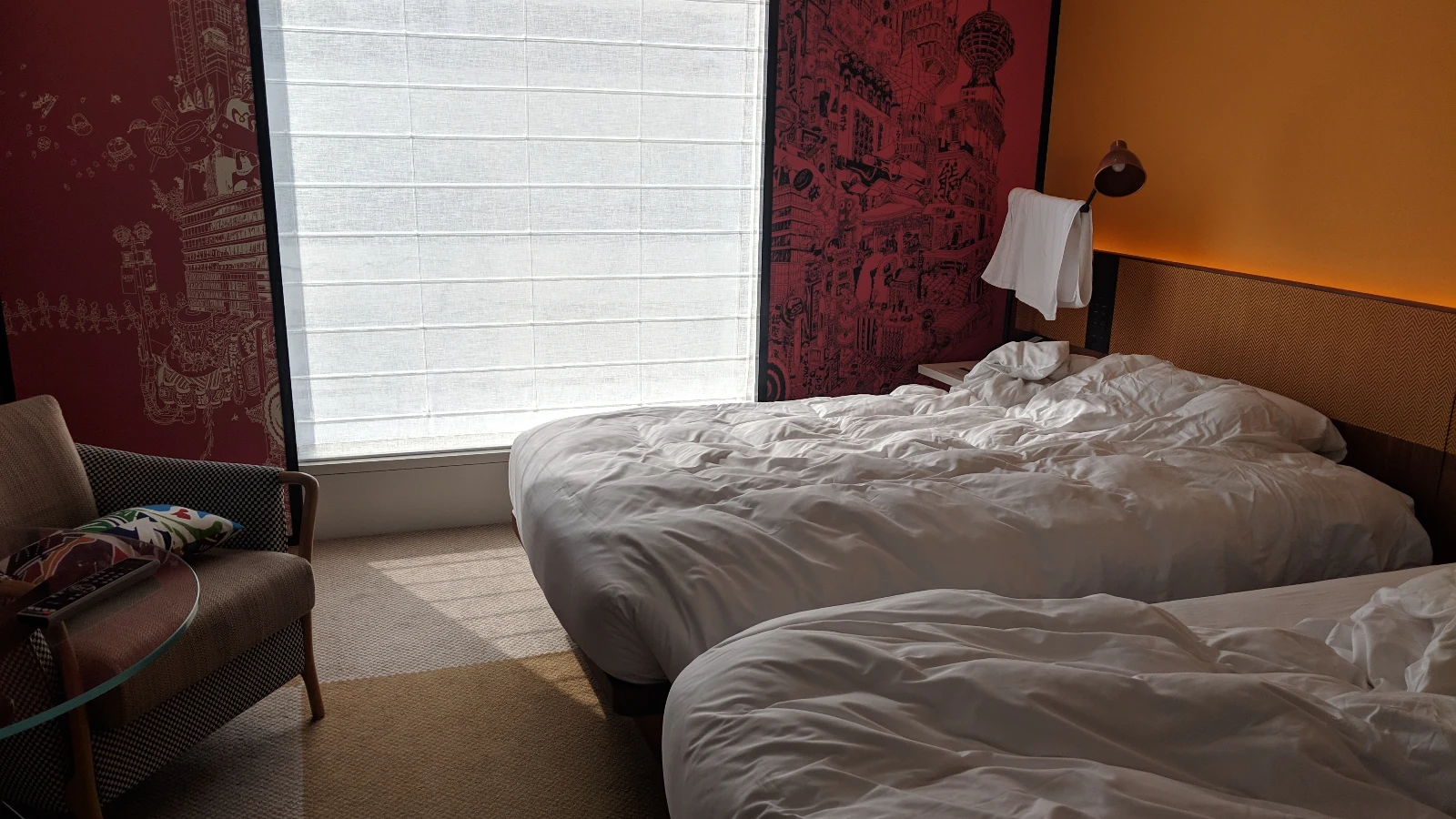 Family-friendly hotel room in Osaka with twin beds and playful decor, ideal for travelers looking for the best hotels in Osaka for families.
