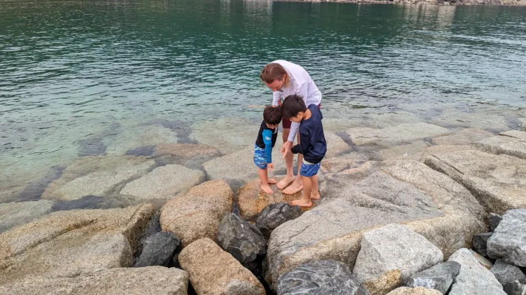 Papa, Luca & Nico explore tide pools along the rocky shoreline at Keya Beach, part of their Fukuoka itinerary with kids.