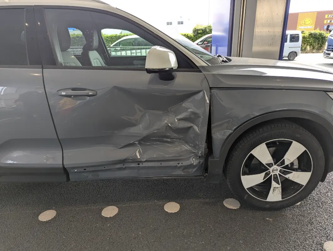 Side of the family’s car after a roadside accident during a spring trip across Japan with kids.