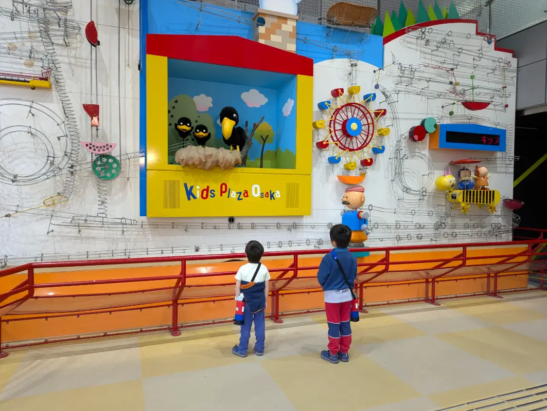 Luca and Nico climbing the central play structure at Kids Plaza Osaka in Osaka, Japan.