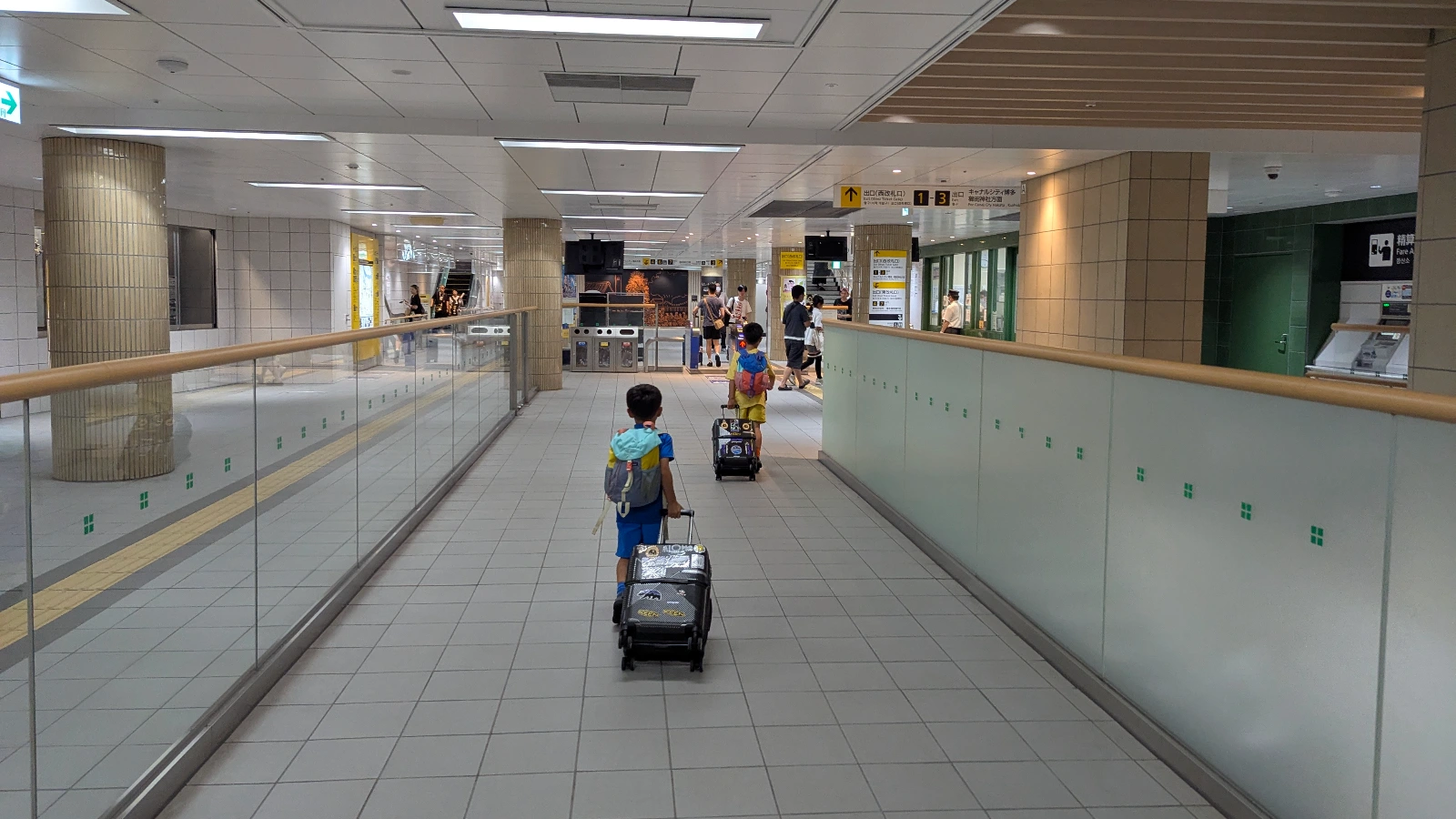 Luca and Nico using the Fukuoka Subway during their family trip, exploring city attractions with the 1-Day Subway Pass
