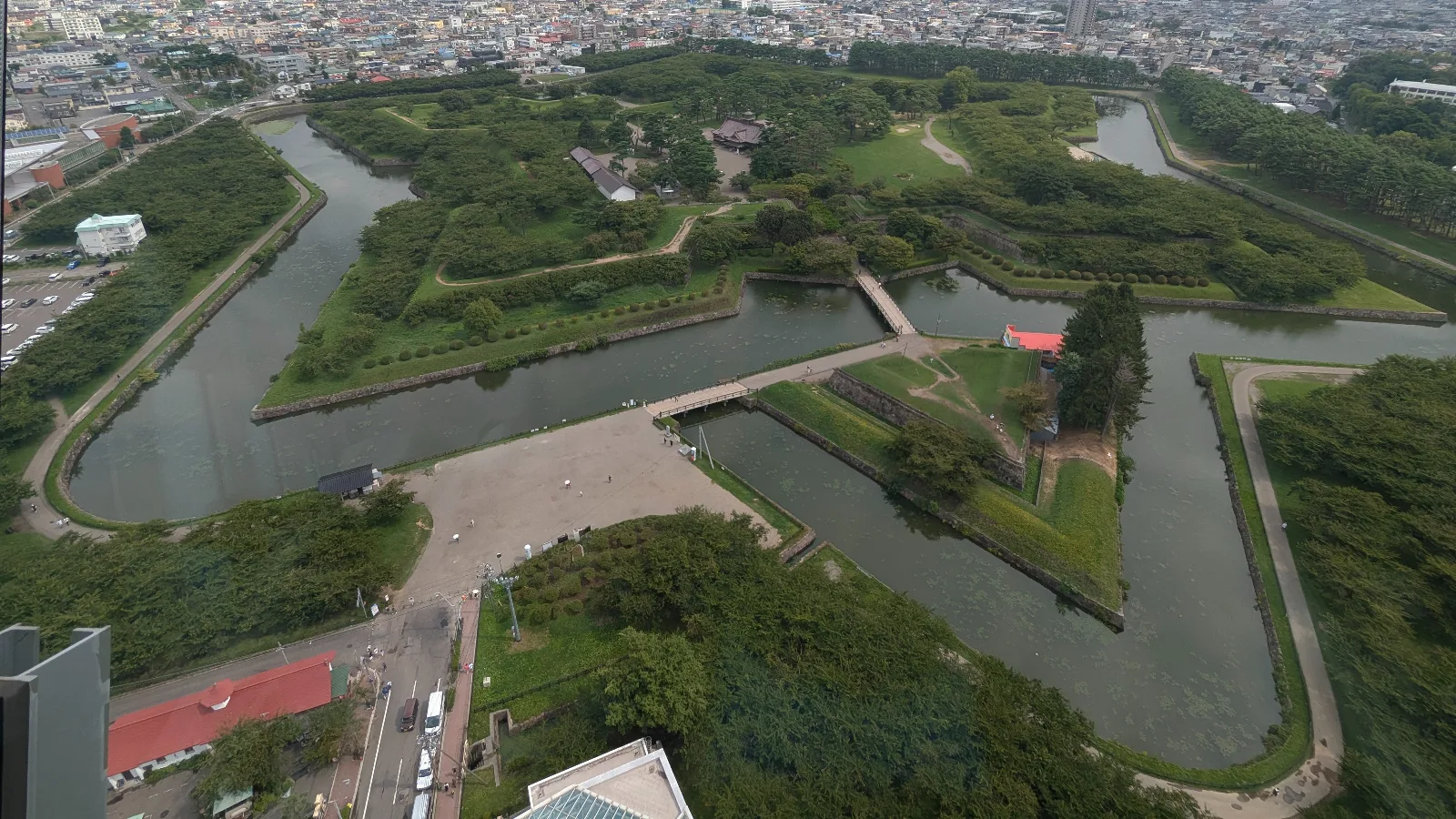 Aerial view of Goryōkaku’s star-shaped fort and moat surrounded by trees and walking paths, seen from Goryōkaku Tower in Hakodate.