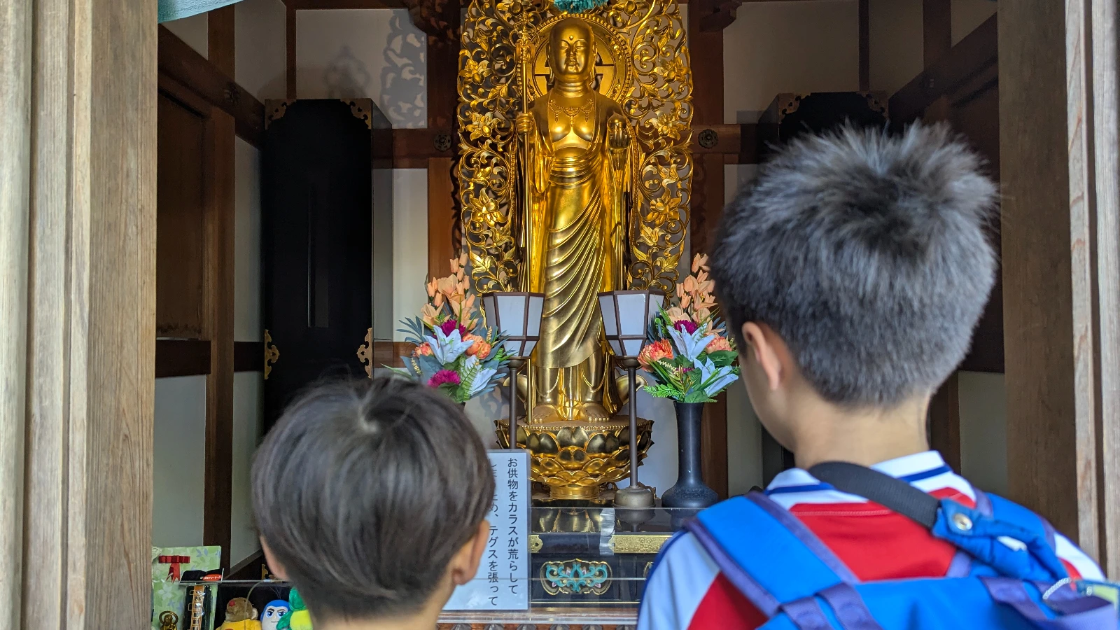 Luca and Nico looking at the golden Amida Buddha inside the Amida-do Hall at Hasedera Temple in Kamakura.