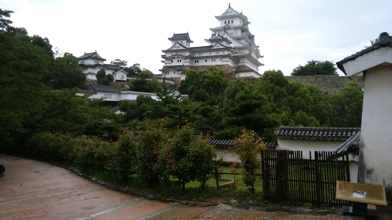 View of Himeji Castle (Himeji-jo) in Hyogo Prefecture, Japan, surrounded by trees and traditional buildings, perfect for a family day trip.