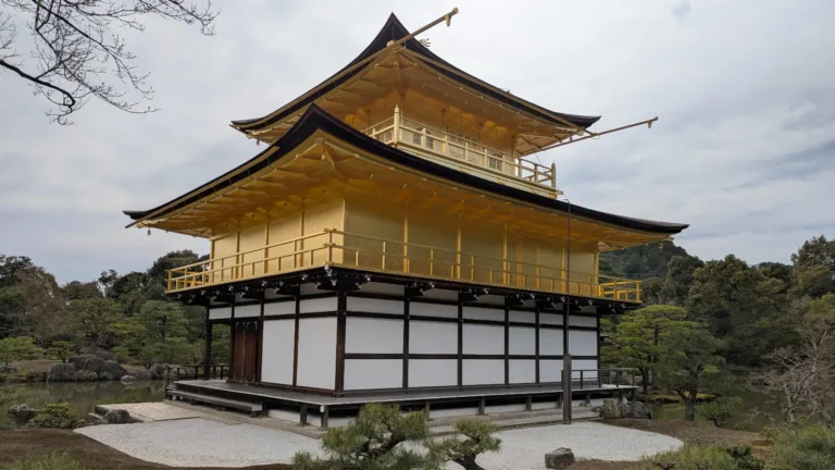 Kinkakuji Temple glowing under spring skies in Kyoto, a magical stop for families exploring history, imagination, and golden treasures with kids.