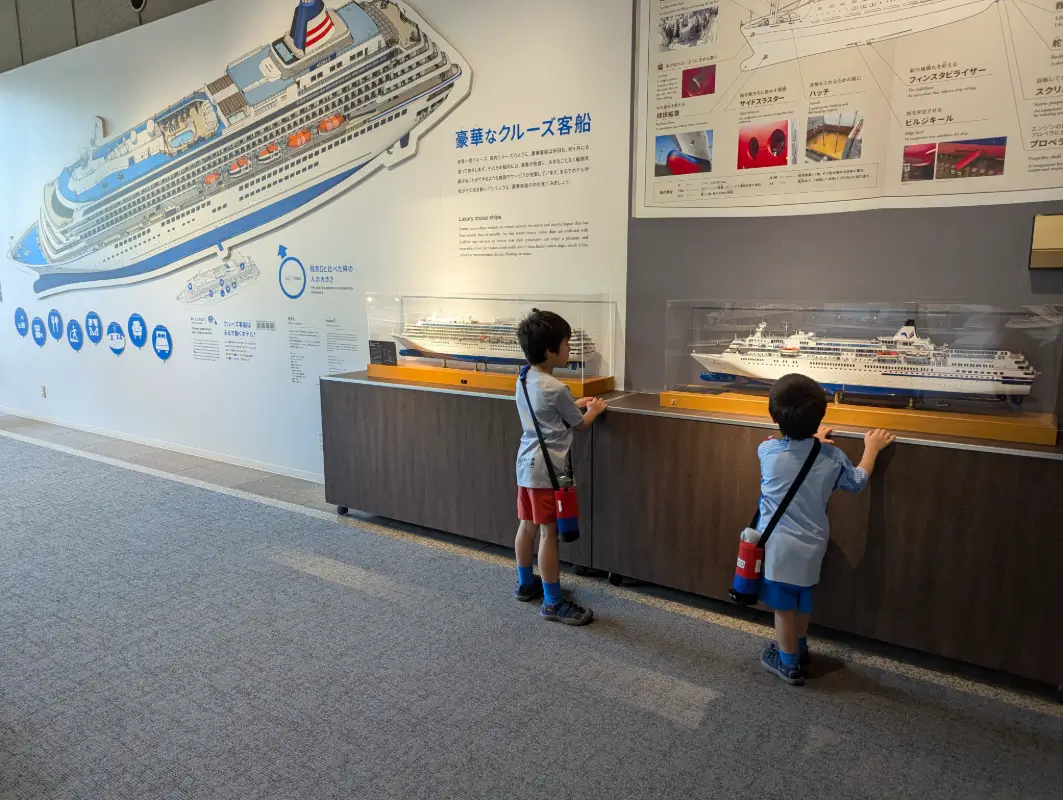 Luca & Nico exploring ship exhibits at Kobe Maritime Museum, kobe family travel guide.