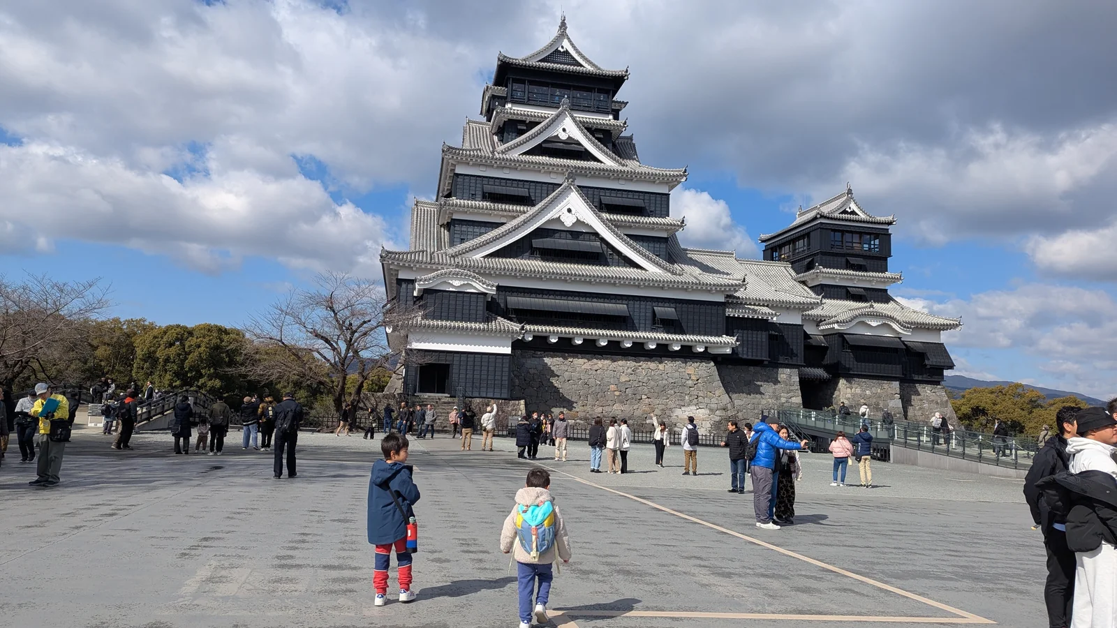 Luca and Nico exploring the courtyard at Kumamoto Castle in Kumamoto, Japan.