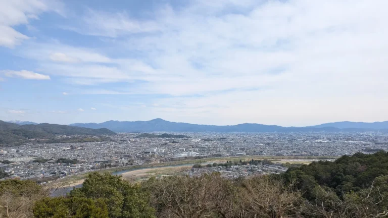 View over Kyoto city from Arashiyama Monkey Park during spring, where kids can enjoy nature, wildlife, and panoramic scenery.