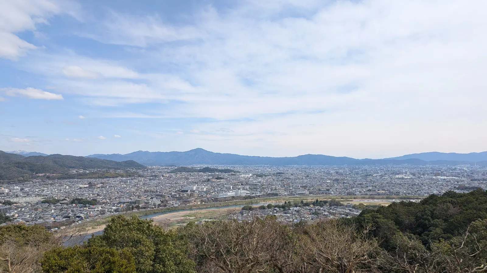 View over Kyoto city from Arashiyama Monkey Park during spring, where kids can enjoy nature, wildlife, and panoramic scenery.
