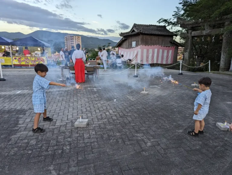 Luca and Nico play with sparklers at a local autumn festival in Japan, celebrating the vibrant seasonal traditions featured in this Japan Seasonal Family Travel Guide.