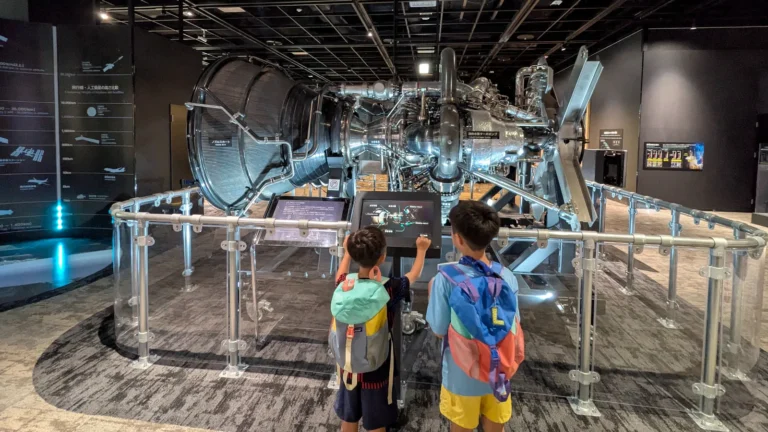 Luca and Nico exploring a rocket engine exhibit at the Mitsubishi Minatomirai Industrial Museum in Yokohama, a hands-on science and technology museum for kids.