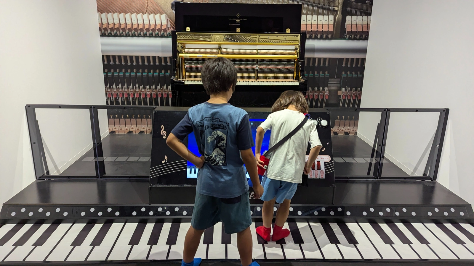 Luca and Nico play a giant floor piano at the Museum of Musical Instruments in Hamamatsu.