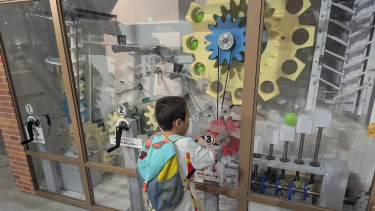 Nico interacts with a hands-on science exhibit at the Nagasaki Science Museum, one of the top indoor attractions for families in Nagasaki.
