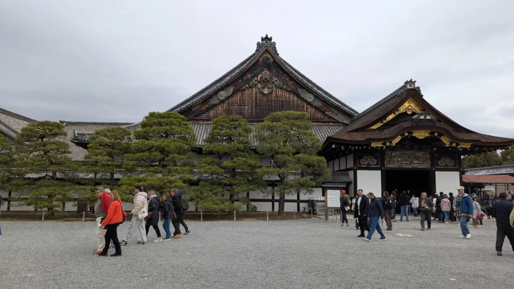 Visitors exploring the front entrance of Nijo Castle’s Ninomaru Palace in Kyoto, a top family-friendly cultural site in Japan.