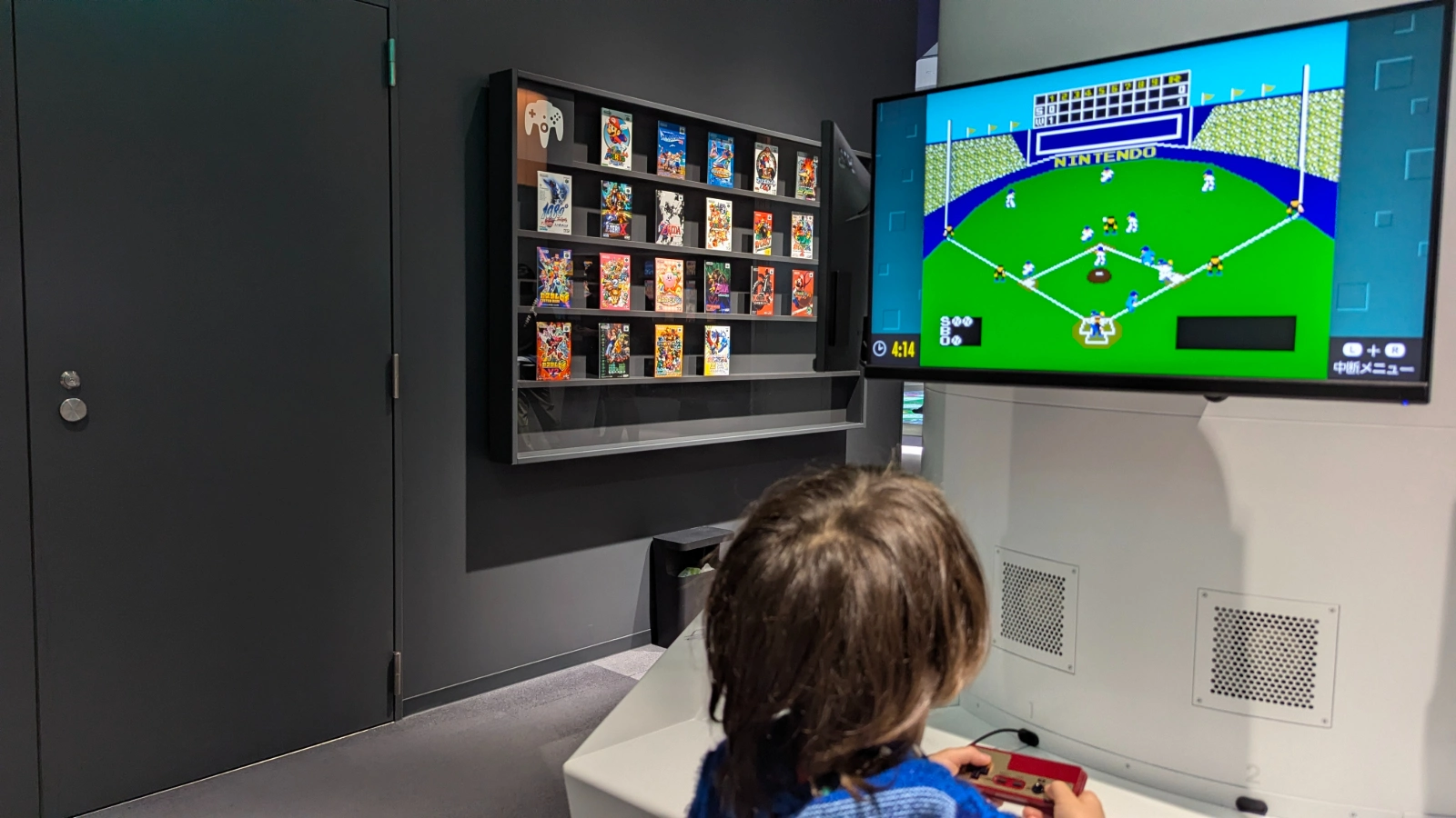 Luca and Nico playing a Famicom baseball game at the Nintendo Museum in Uji, Kyoto, Japan.