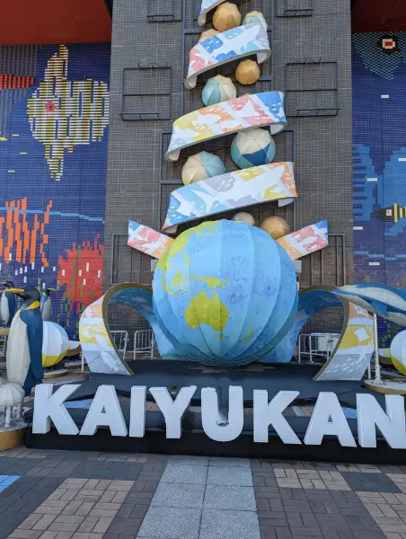 Decorative globe and marine-themed sculpture at the entrance of Osaka’s Kaiyukan Aquarium, welcoming families to an ocean-inspired adventure.