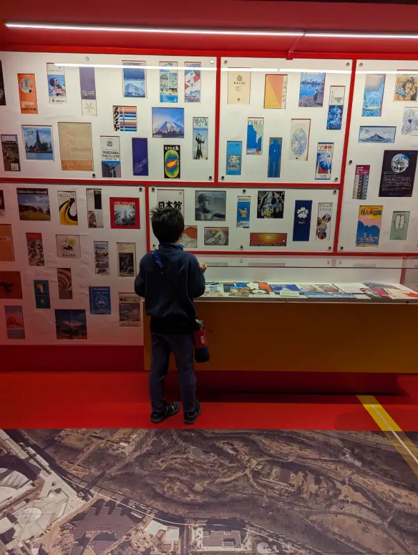 Luca studies a colorful display of international posters from the 1970 World Expo at Expo ’70 Park in Osaka, Japan.