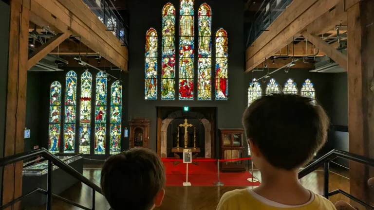Two children admire colorful stained glass windows inside the Otaru Stained Glass Museum, one of Otaru’s most beautiful family-friendly attractions.