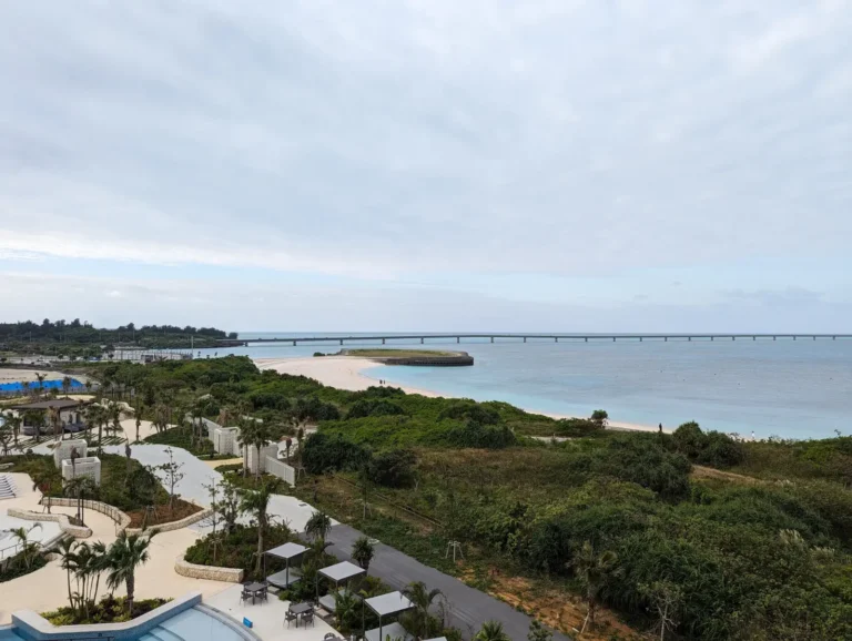Stunning view of Miyakojima's (Miyako Island) tropical coastline and Yonaha Maehama Beach from the Hilton Miyakojima Resort, showcasing pristine waters and lush greenery, perfect for a family-friendly getaway.