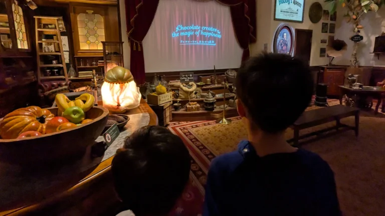 Two children watch a short film inside Shiroi Koibito Park’s chocolate factory in Sapporo, surrounded by vintage décor and sweet aromas of cocoa.