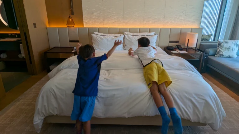 Luca & Nico jumping onto a hotel bed at The Westin Yokohama, Japan, a luxury family-friendly hotel in Minato Mirai
