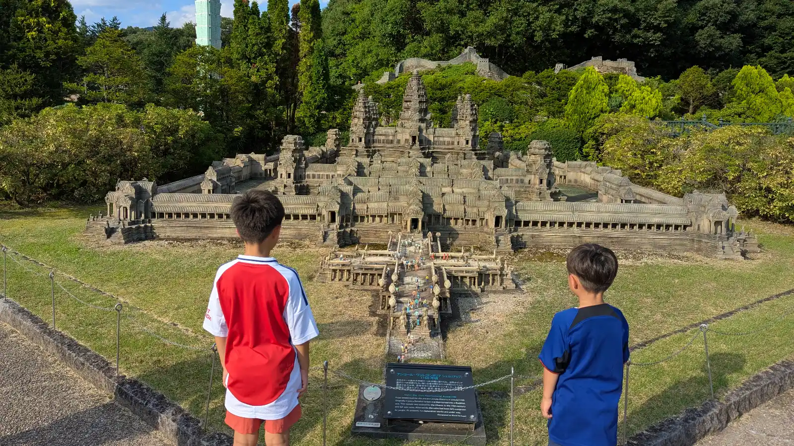 Kids standing in front of the Angkor Wat miniature replica at Tobu World Square in Nikko, Japan.