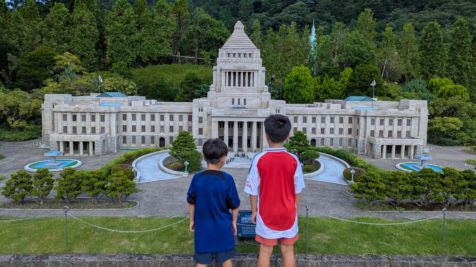 Children looking at the National Diet Building miniature model at Tobu World Square in Nikko, Japan.