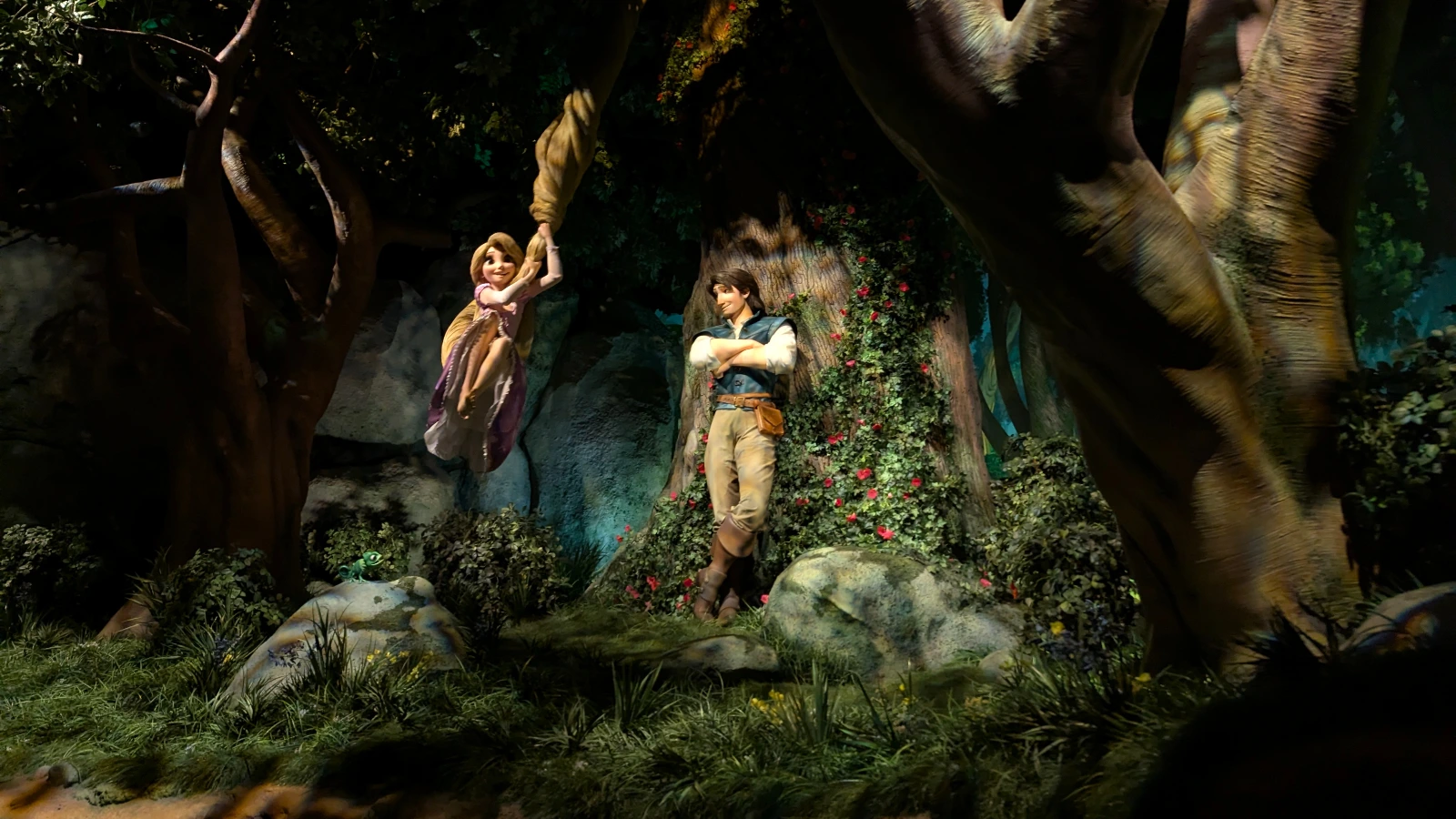 Rapunzel swings from her hair toward Flynn Rider in a detailed animatronic forest scene inside Tokyo DisneySea’s Fantasy Springs.