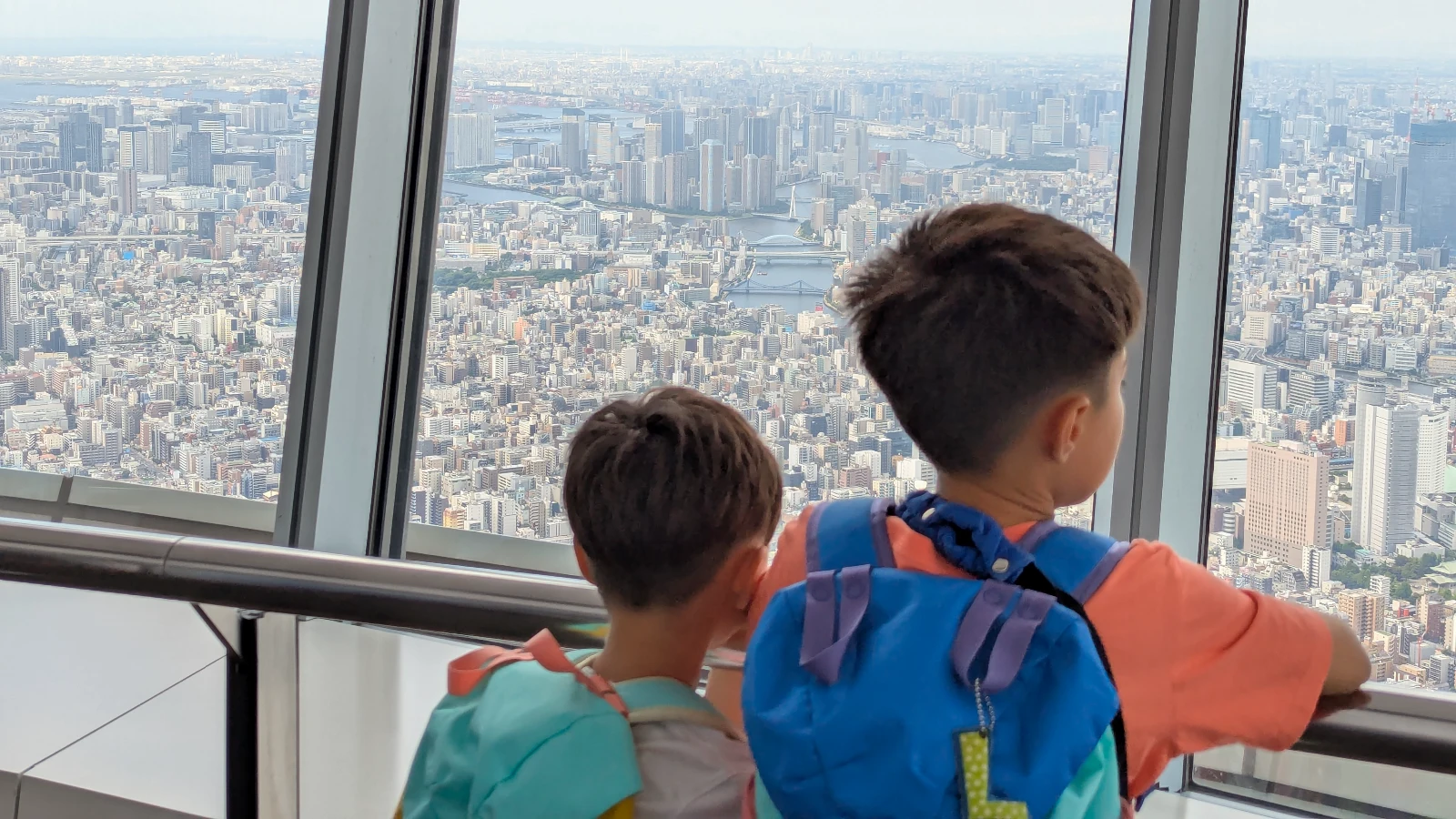 View of Tokyo Skytree tower with clear blue sky, showing the iconic landmark as seen during a family visit with kids.