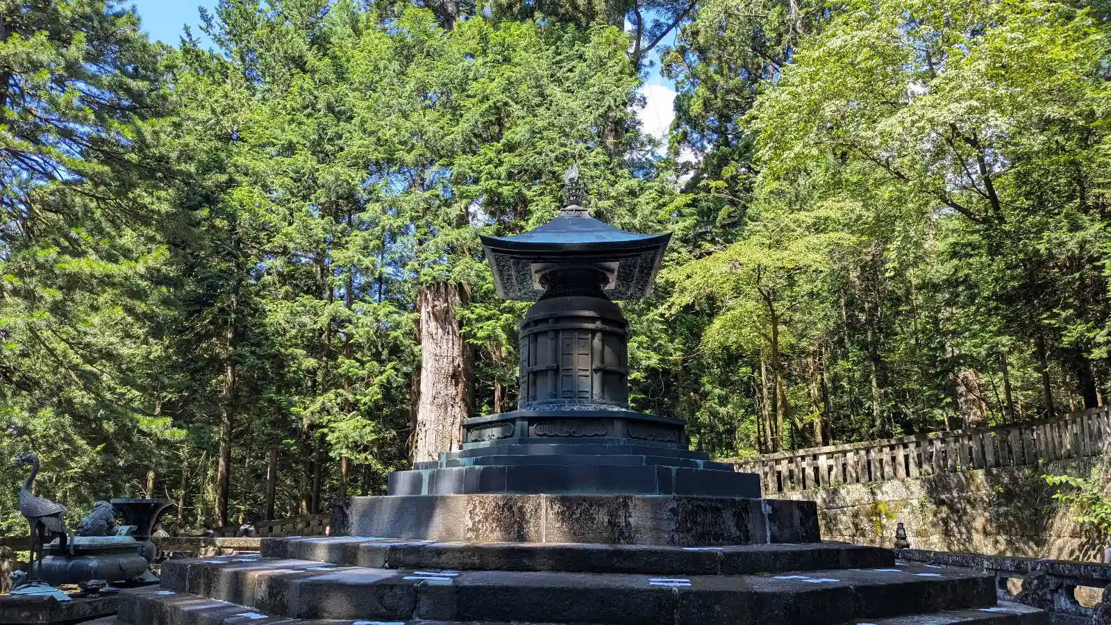 Tokugawa Ieyasu's mausoleum at Toshogu Shrine in Nikko, surrounded by tall cedar trees and stone steps, a quiet and scenic spot for families visiting Japan.