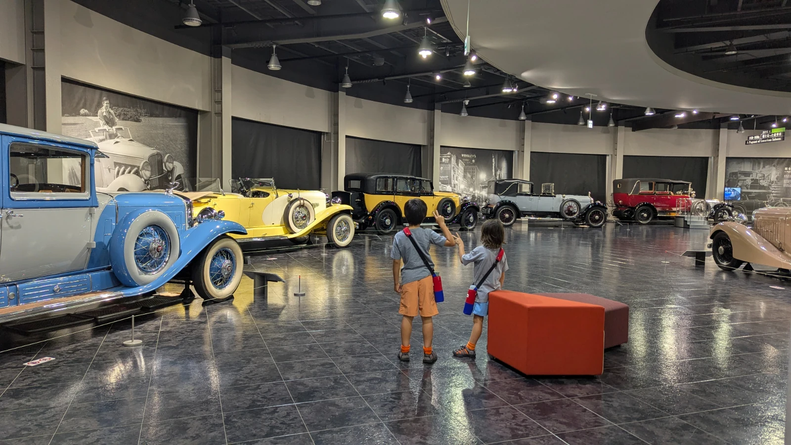 Luca and Nico look over 1920s and 1930s luxury cars in a round gallery at the Toyota Automobile Museum in Nagakute, Aichi.