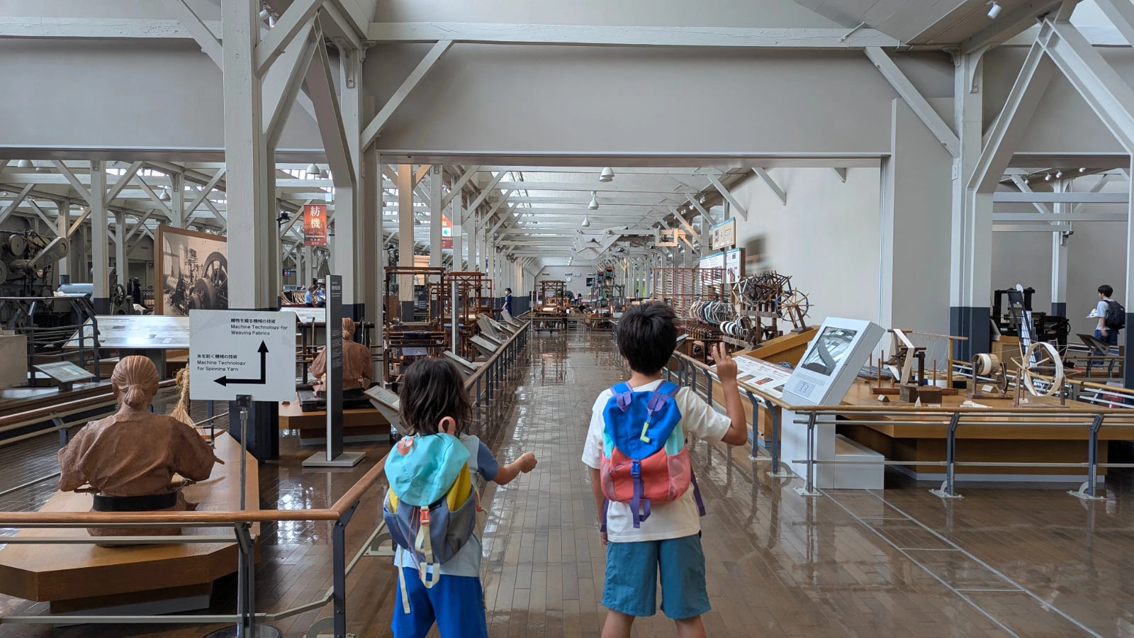 Luca and Nico walk a hall of looms at the Toyota Commemorative Museum of Industry and Technology in Nagoya.