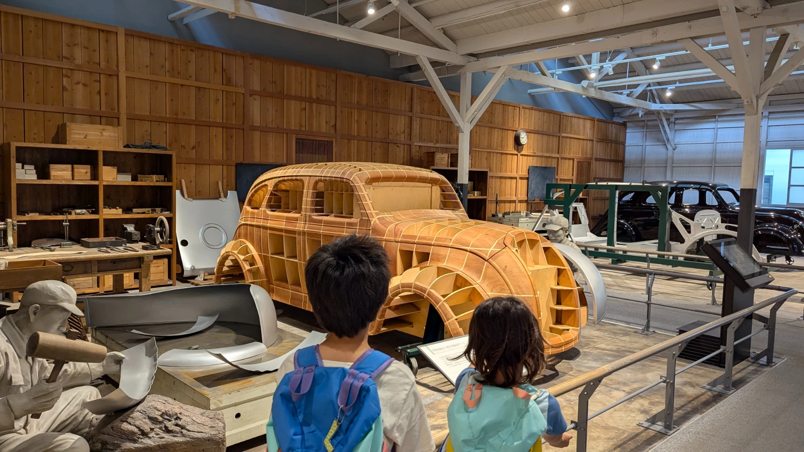 Luca and Nico study a wooden car body model at the Toyota Commemorative Museum of Industry and Technology in Nagoya.