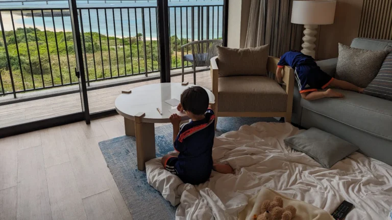 Kids resting and decompressing in a hotel room during a family trip to Japan, showing a calm recovery moment after a busy travel day.