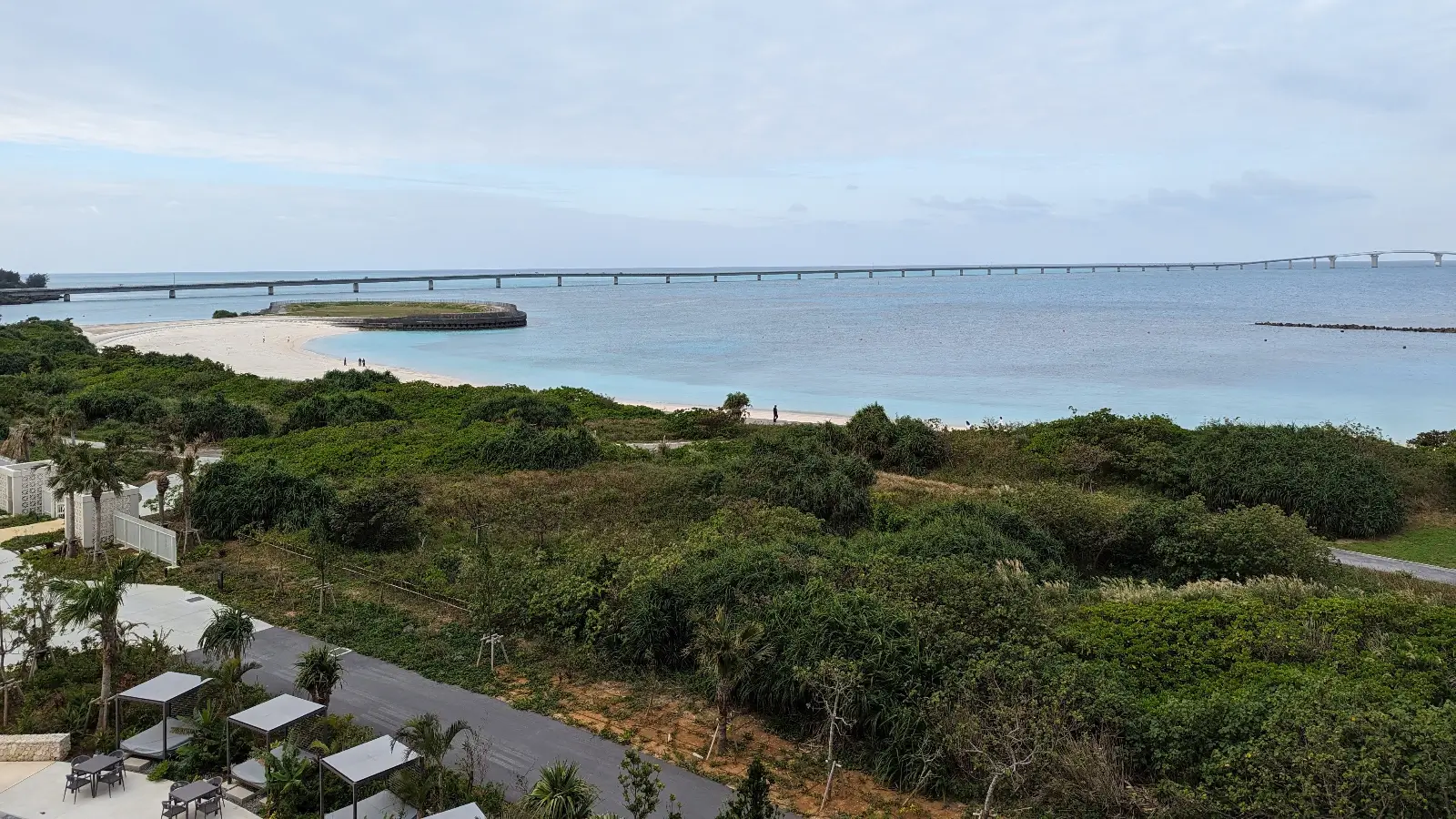 Stunning view of Miyakojima's (Miyako Island) tropical coastline and Yonaha Maehama Beach from the Hilton Miyakojima Resort, showcasing pristine waters and lush greenery, perfect for a family-friendly getaway.