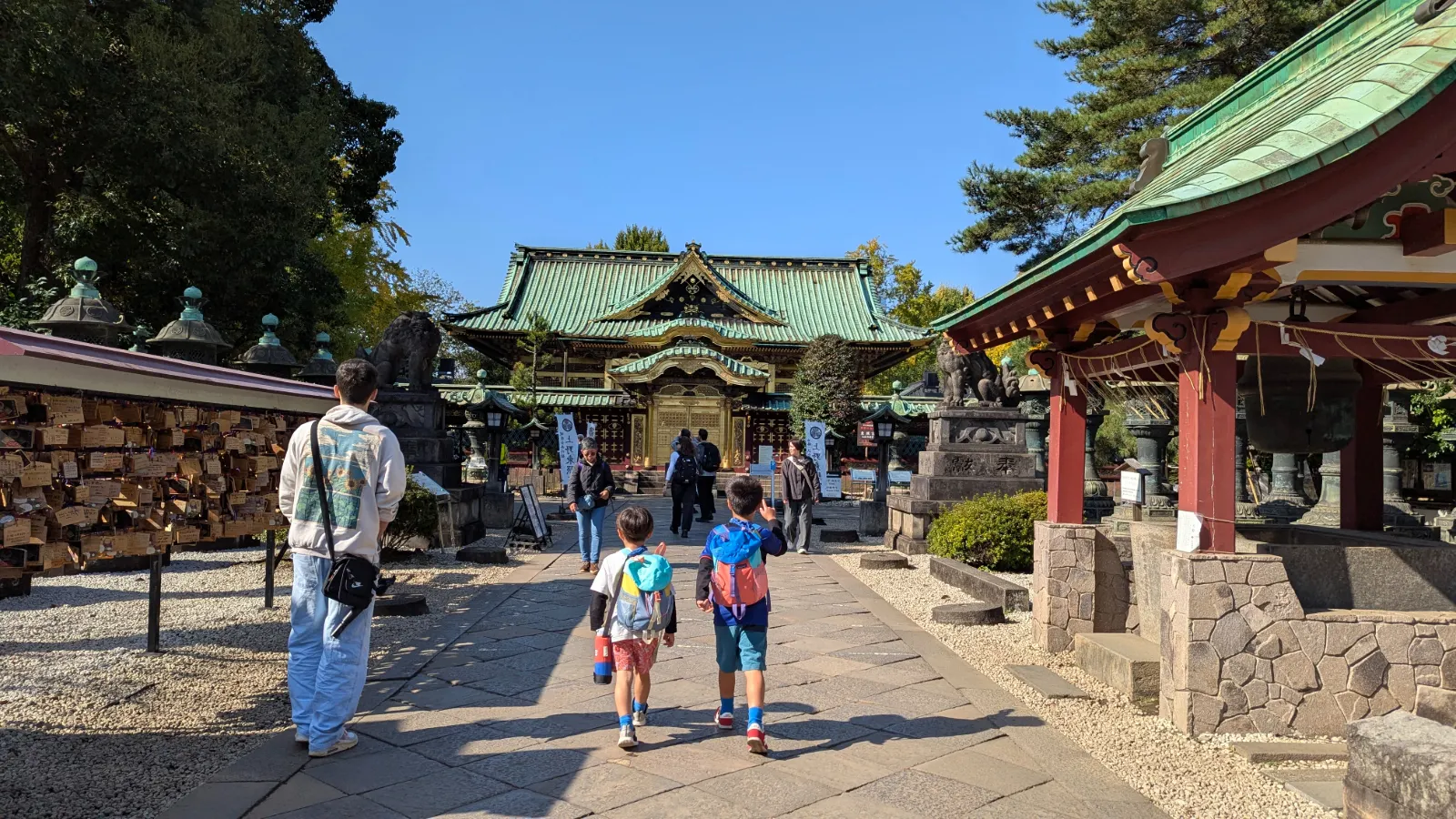 Luca and Nico walking toward a traditional shrine in Ueno, showing how families can enjoy cultural sights on foot while staying in the neighborhood
