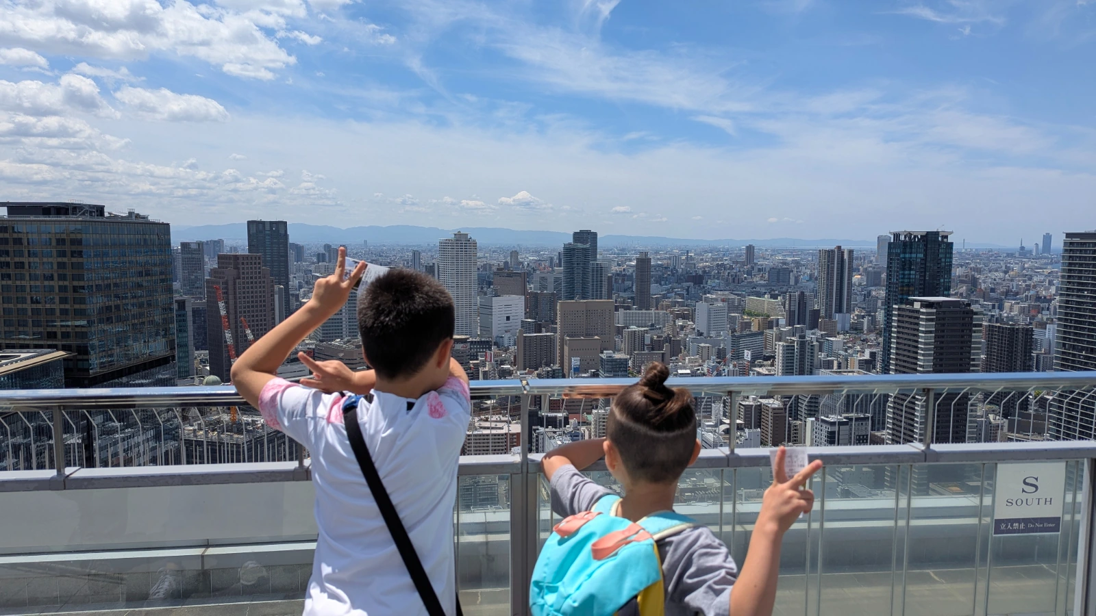 Luca and Nico looking out over the Osaka skyline from the rooftop observatory at the Umeda Sky Building in Osaka.